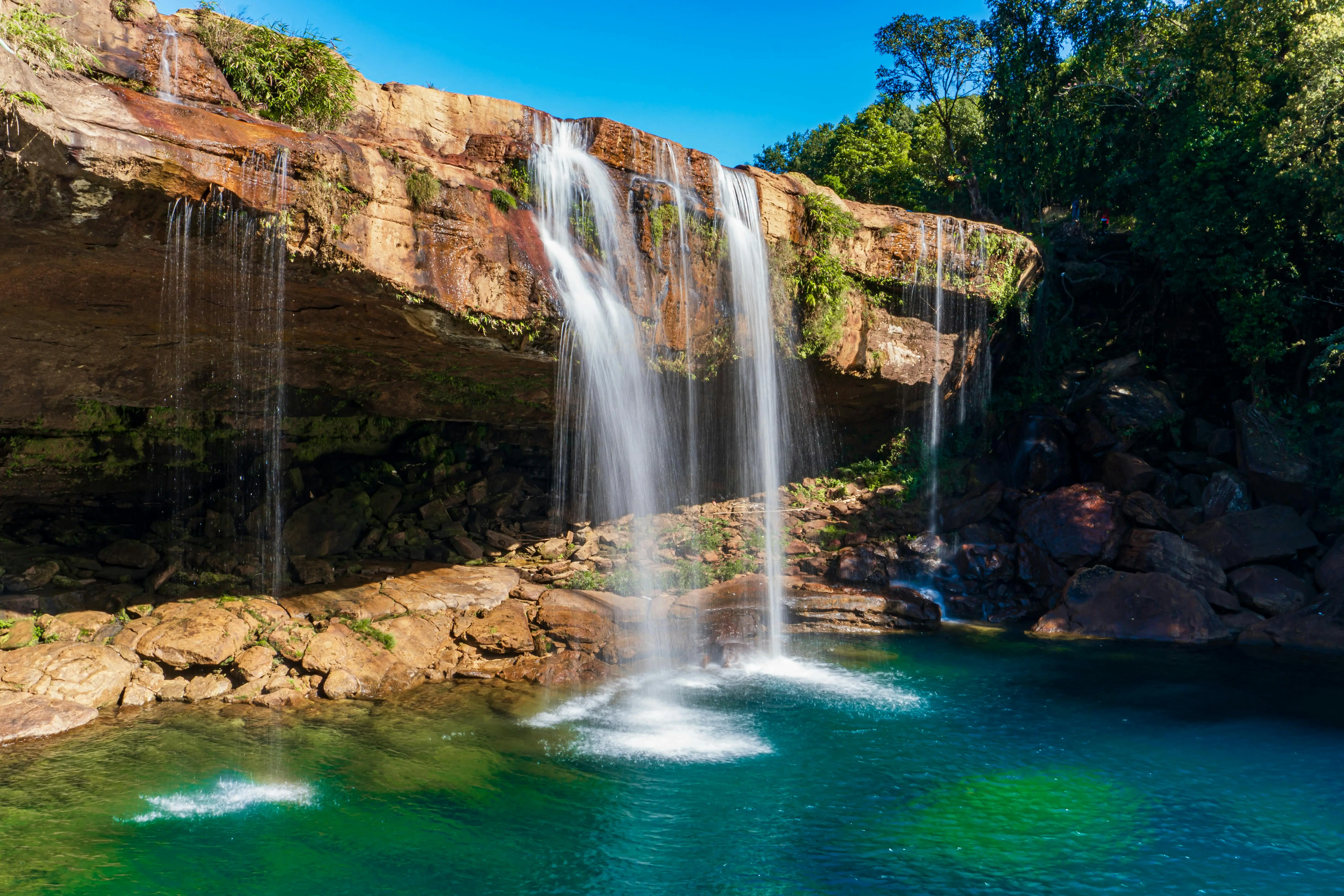 A stunning waterfall with crystal clear blue lake in Meghalaya